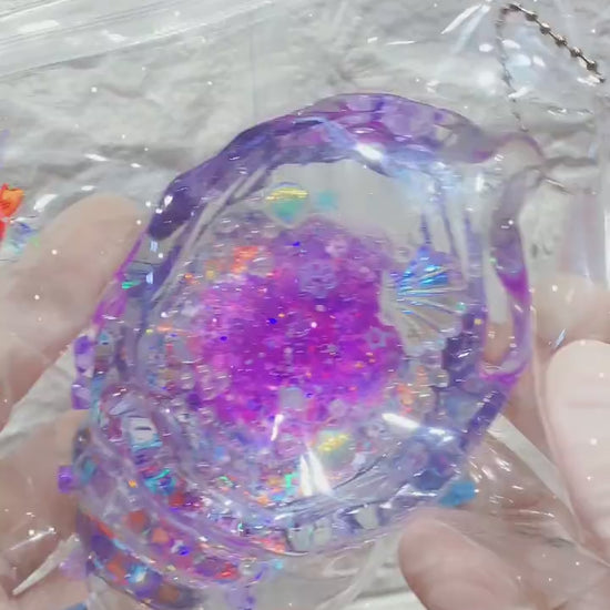 Squishy de concha con purpurina holográfica